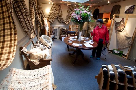 Maggie Skinner examines work at the Shetland Organics display at Vaila Fine Art, part of Wool Week. Pic. Billy Fox