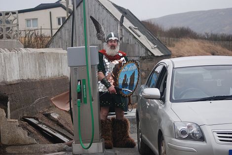 Last year's Northmavine jarl Ian Nicolson fills up at the new Hillswick pumps when they first opened a year ago. The birthday is being celebrated with the cheapest fuel in Shetland - Photo: Maree Hay, NCDC