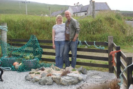 Julie Redrup and John Kenyon survey their work creating a community garden at the Fetlar Interpretive Centre. Pic. RSPB