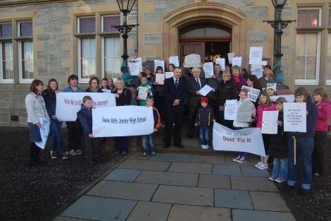 West side parents hand in a 1,048 signature petition to local member Theo Smith and council leader Gary Robinson ahead of Thursday's meeting. Pic. Shetland News