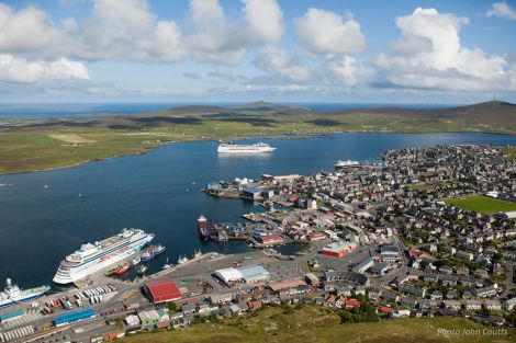 A busy day at Lerwick Harbour this summer, with three cruise ships in port - from left to right, AIDACara (alongside Holmsgarth), MSC Poesia (at anchor) and National Geographic Explorer (alongside Victoria Pier) - Photo: John Coutts/LPA