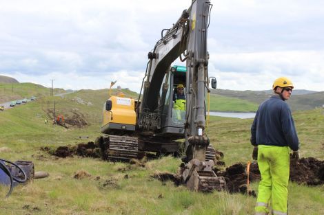 Workmen dig a hole for a new pole as part of the new Northmavine power line. Photo ShetNews