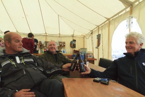 Sailors George, Dave and Decland enjoy Lerwick Brewery's new beer at the Skeld Regatta on Friday. Photo Olivia Abbott