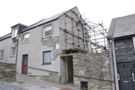 The property in Pitt Lane with scaffolding erected four years ago to support a bulging gable end. Photo Shetnews