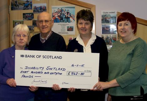 Laureen Fraser and James Smith of the Shetland ex-Whalers Association present the £862 cheque to Joyce Henderson and Eleanor Robertson of Disability Shetland.