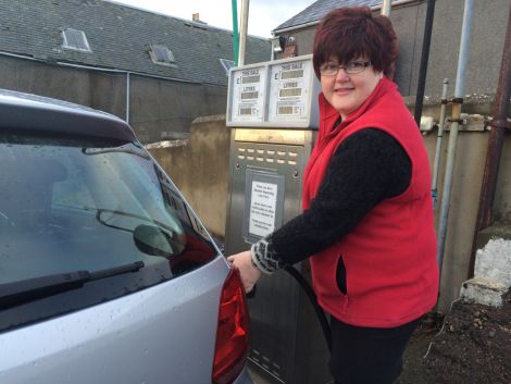 Hillswick Shop manageress Sheila Tulloch filling up while fuel is cheap. Photo ShetNews