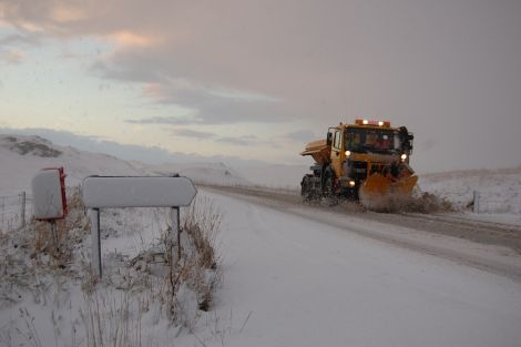 A snow plough in action two winters ago. The Met Office is forecasting 5-10cm of snowfall overnight.