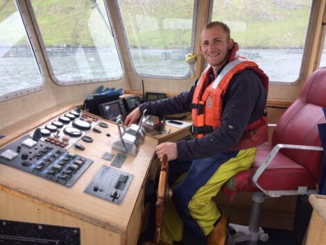 Scottish Sea farms modern apprentice Martin Mladenov at the helm of his workboat.