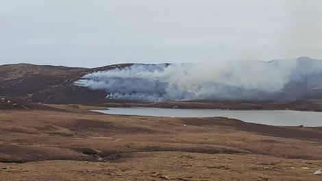 A grass fire in Sandness threatened nearby overhead power lines. Photo Michael Mann