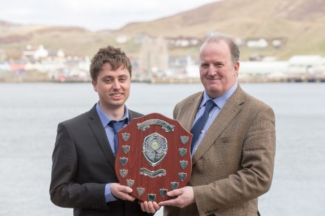 Fish farm worker Shaun McAlister receives his award from SSPO Shetland general manager Davie Sandison.