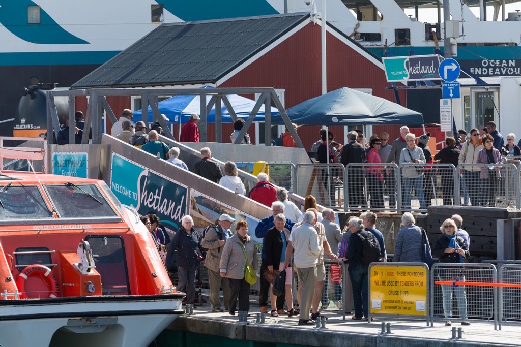 Cruise passengers step ashore on the new pontoons at Lerwick's Victoria Pier. Photo LPA