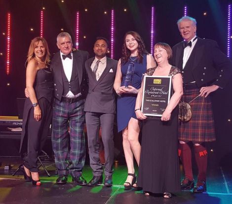 Celebrating another award for Scalloway Hotel are (left to right): TV presenter Carol Smilie, owner Peter Mackenzie, Scalloway Hotel employees Akshay Borges and Adel Smith, owner Caroline Mackenzie and author Roddy Martine.
