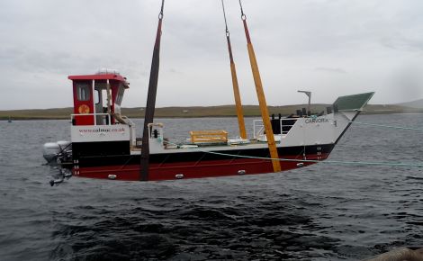 The new Kerrera ferry Carvoria is being lowered into the water at Lerwick harbour. Photo: CMAL