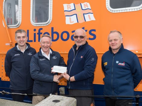 NorthLink's freight manager Kris Bevan and managing director Stuart Garrett with Aith lifeboat's Hylton Henry and RNLI Kirkwall's Graham Campbell.
