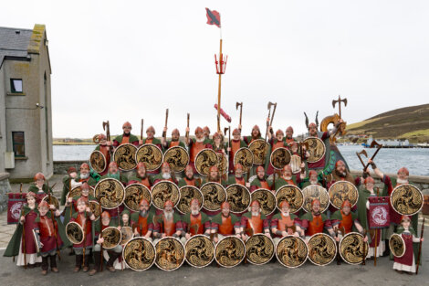A group of people dressed in viking costumes posing for a photo.