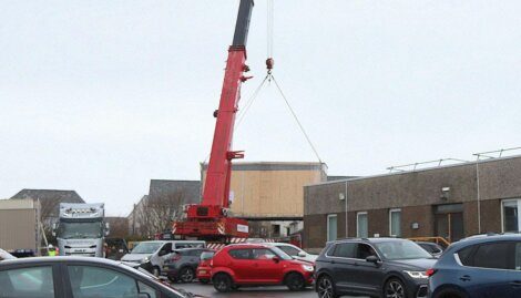A crane lifting a car.
