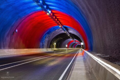 A tunnel with red, blue, and green lights.