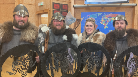 A group of people in viking costumes posing for a photo.